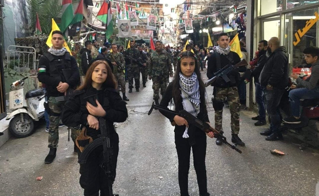 Palestinian girls bearing assault rifles in a military parade: Palestinian President Mahmoud Abbas’ Fatah party posted this photo on its Facebook page. Defeat of Israel and hatred of Jews remains the focal point of Palestinian society, causing Palestinians to malign Israel even as Israel offers to help them defeat Covid-19. (Photo thanks to Palestinian Media Watch.) 