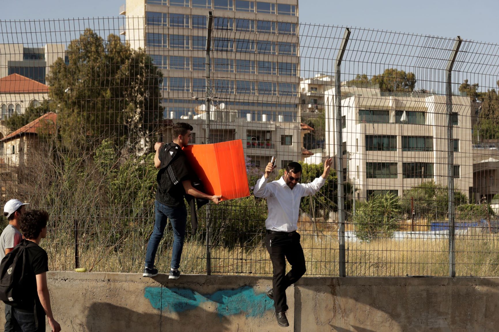 Palestinian protester in Sheikh Jarrah attacks Rabbi Yonatan Yosef. While Palestinians who for decades have refused to pay their rent for Jewish-owned homes face legal action, the Associated Press caption to this photo tells of “forcible evictions from their homes by Jewish settlers.” June 8, 2021
