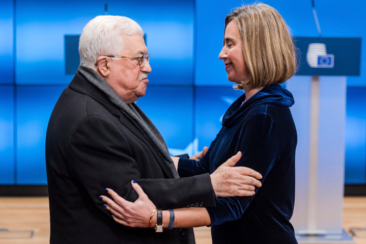 Palestinian President Mahmoud Abbas gets a hug from European Union Foreign Minister Federica Mogherini. EU efforts to make peace between Israel and the Palestinians include funding anti-Semitic Palestinian organizations and schoolbooks and censuring nations intending to locate embassies in Jerusalem.