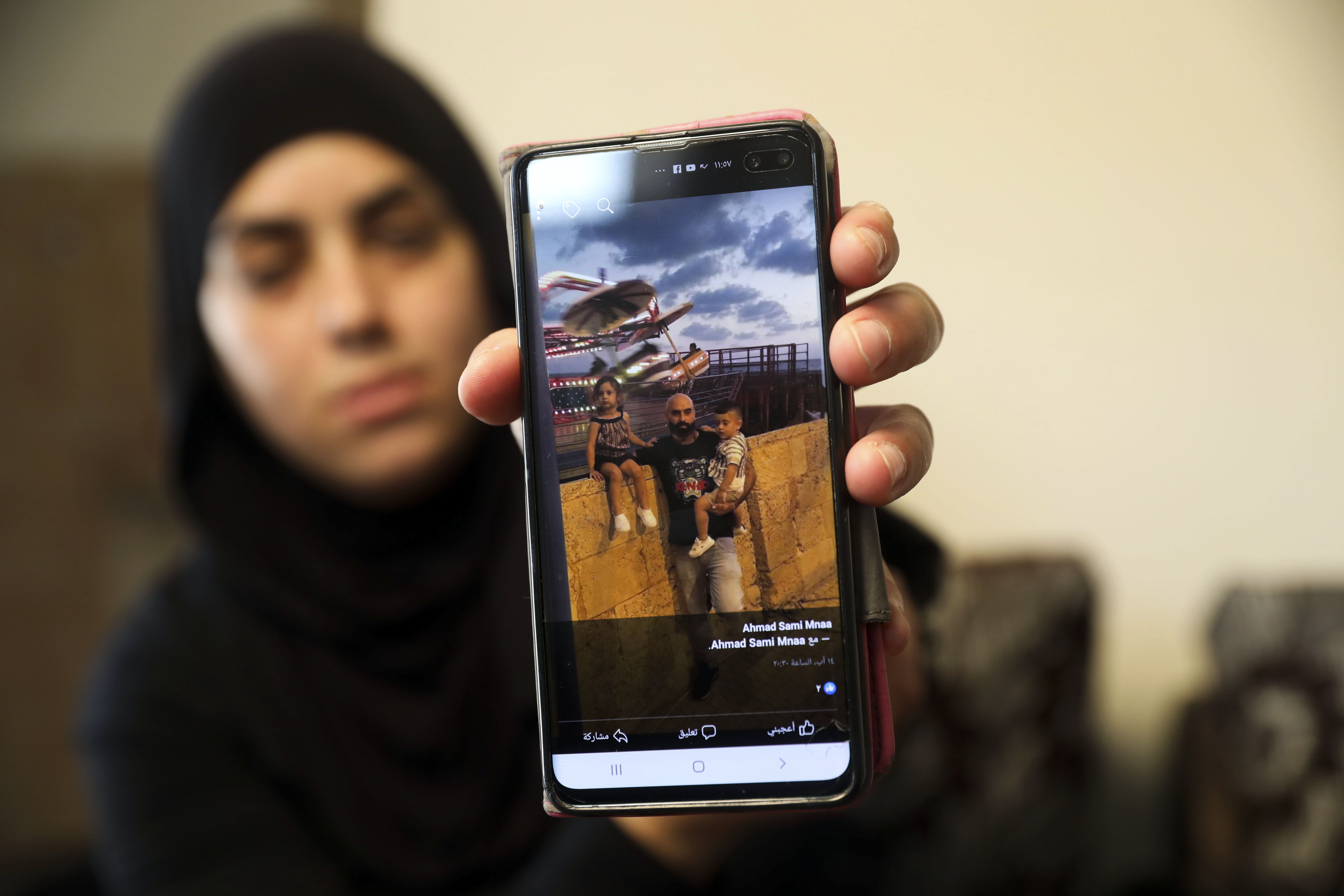 An Israeli Arab woman shows a photo of her dead brother, one of two of her siblings recently killed in a midday shootout in Majd al-Krum.  According to the Associated Press, “a wave of violent crime in Israel’s Arab communities has exposed the longstanding mistrust between the marginalized community and Israeli authorities.”