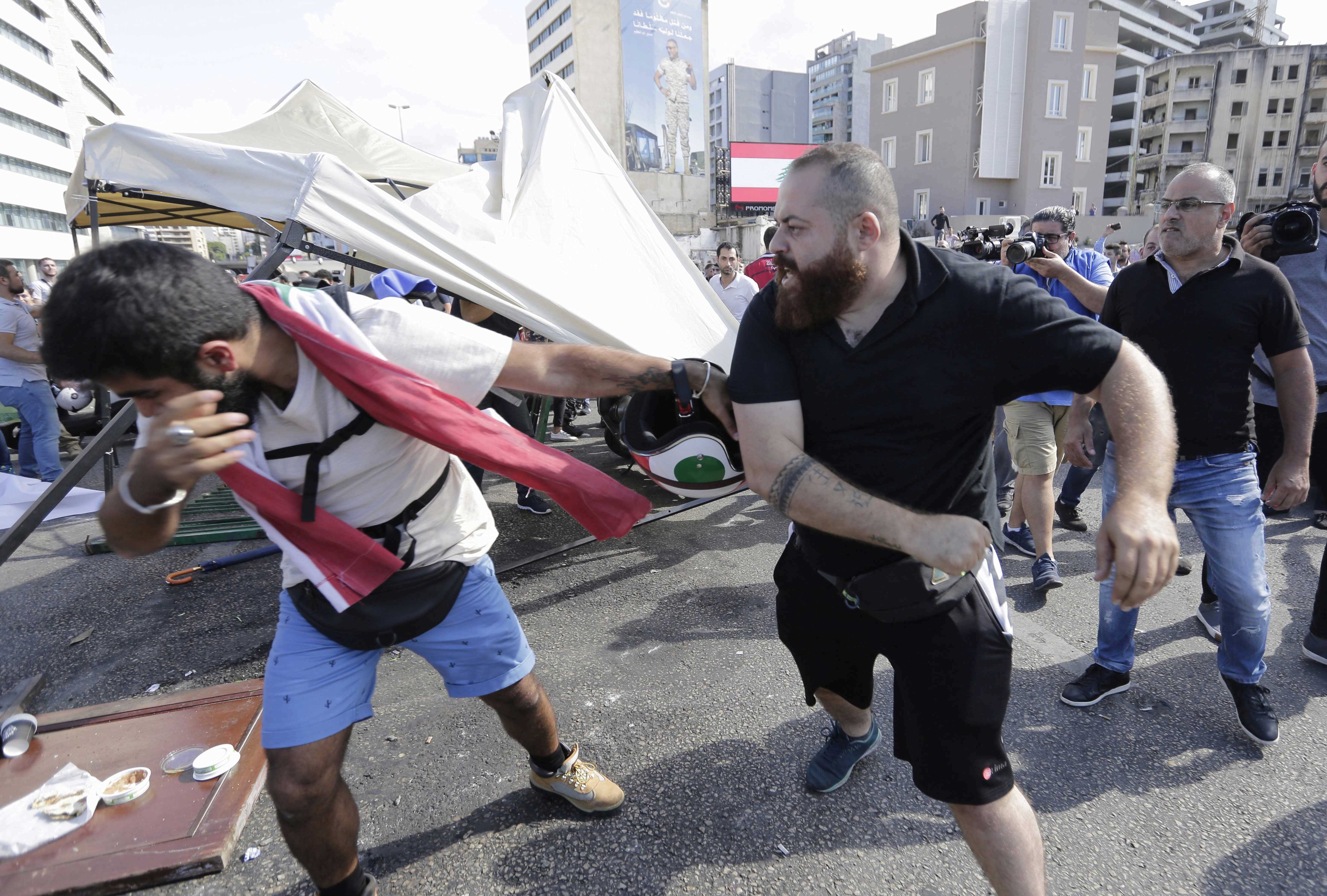 Black-shirted Hizbullah thugs assault anti-government demonstrators in Beirut. The Hizbullah agents tore down and burned protest tents, and sent numerous protesters to the hospital. Hizbullah’s goal: to maintain the corrupt Lebanese power structure over which it has control. 