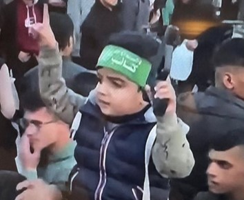 A young Palestinian boy wearing a Hamas headband brandishes a gun in a crowd. From birth, Palestinian children are taught to hate and kill Jews, and destroy Israel. Instead of assuming that Palestinians want peace, Westerners might better ask, what message is this child sending? 