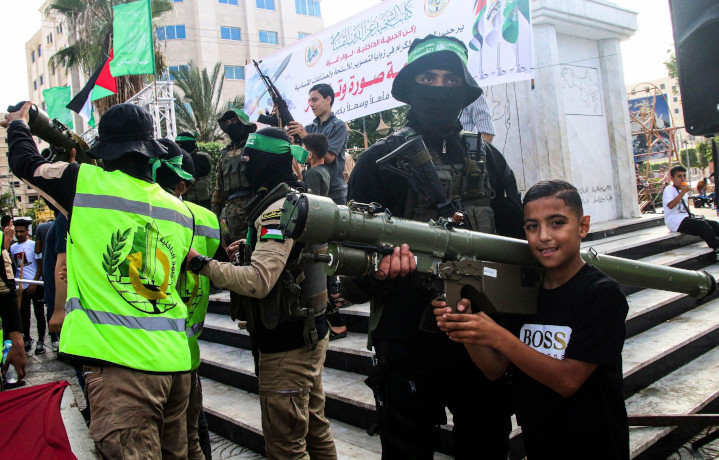 Hamas brandishing their weapons in Gaza City. In service to a pre-ordained fake “narrative,” media outlets blindly swallow and regurgitate lies fed them by the Hamas terror group, often giving them equal—or even greater credibility—than hard evidence provided by Israel. 