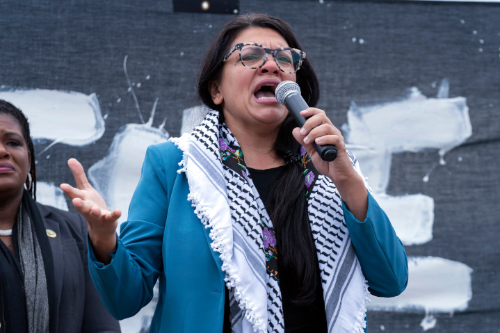 Congresswoman Rashida Tlaib speaks in front of a giant “Ceasefire Now” sign at a pro-Palestinian rally in Washington, DC. Tlaib and other Hamas apologists routinely cite bogus death tolls from Gaza to justify their calls to stop the fighting and ensure Hamas’s survival