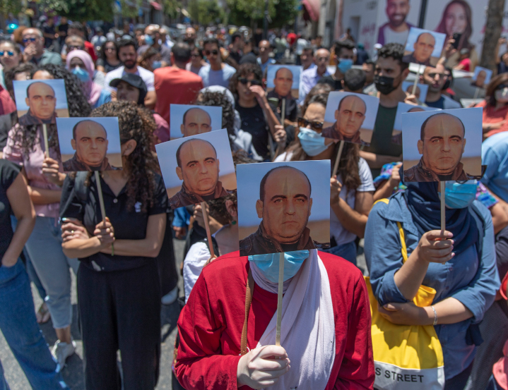 Palestinian protestors in the West Bank hold photos of Nizar Banat, a critic of corruption in the Palestinian Authority, who was arrested and beaten by PA security forces and now is reported dead. Western media and Palestinian supporters ignore such repression by the PA government.