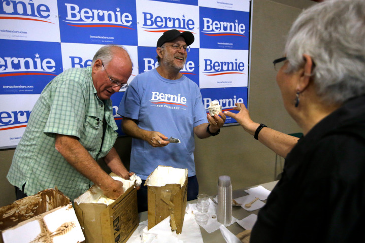 Ben & Jerry’s founders, Ben Cohen, left, and Jerry Greenfield scoop ice cream to support Bernie Sanders’ presidential candidacy. The two wrote a New York Times op-ed supporting their former company’s boycott of Israel, falsely claiming that Israel illegally occupies the West Bank.