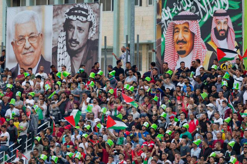 Saudi Arabia continues to support Palestinian statehood, even to its own detriment in negotiations for normalization with Israel. Above, photos of Palestinian leaders Mahmoud Abbas and Yasser Arafat face Saudi Arabian King Salman and Crown Prince Mohammed bin Salman.
