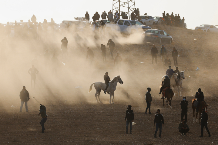 Bedouins clash with Israeli forces during a riot protesting the planting of trees in part of the Negev Desert that tribe members claim is theirs. Though the squatters lack proof of ownership, Israel so far refuses to evict them and enforce rule of law.