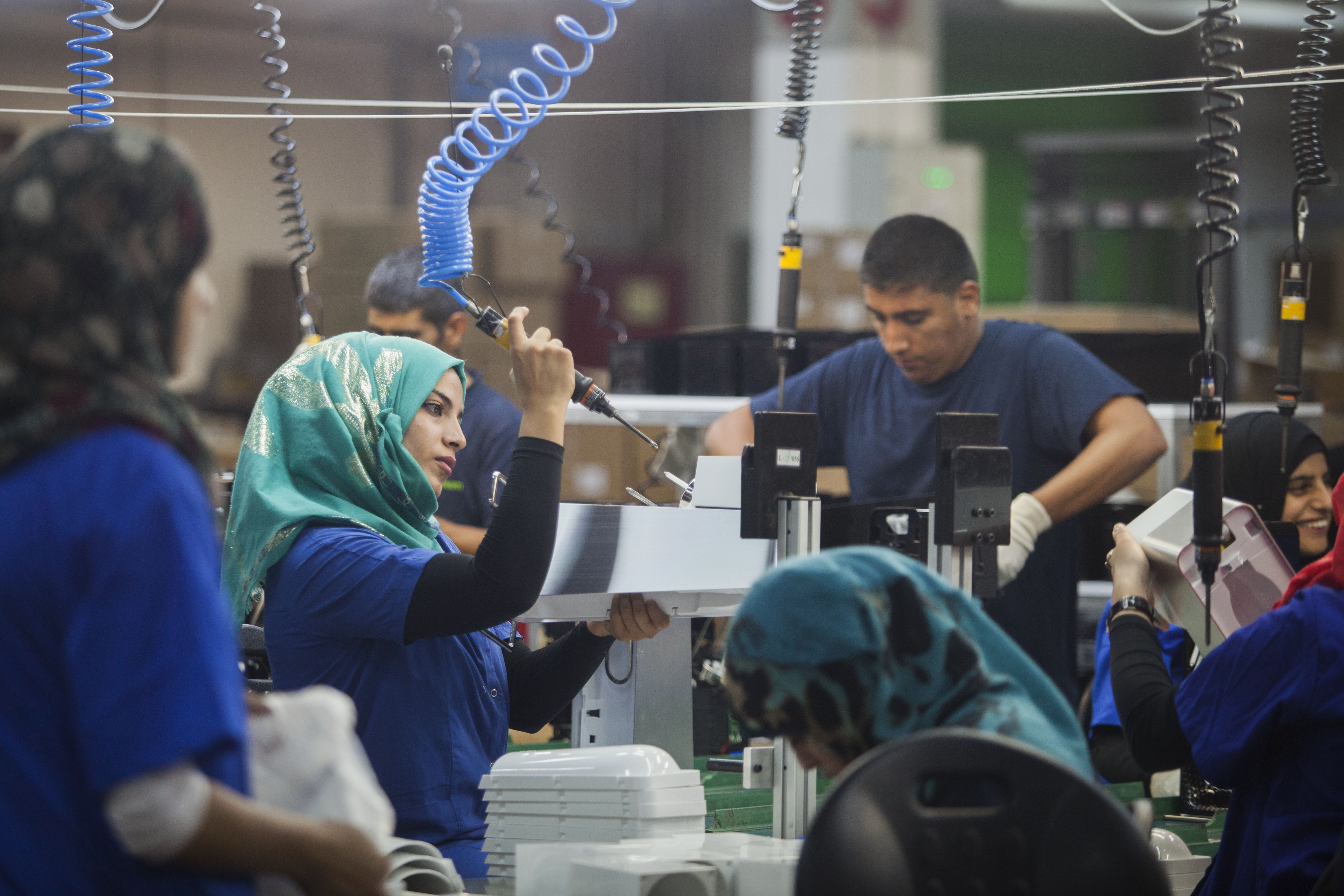 Israelis and Palestinians work side-by-side at a SodaStream factory. If the UN Human Rights Council’s blacklist achieves its goal, the workers will all be out of jobs: The UNHRC considers that the collaborative industry going on here is a “war crime.”