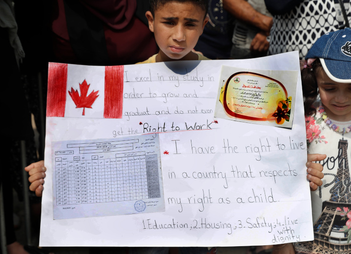 In Beirut, a Palestinian boy pleads for Canadian refugee status: His sign laments, “I study hard to grow and graduate but do not even have the right to work” in Lebanon. His plight reflects the shoddy, second-class treatment hundreds of thousands of Palestinians receive from Arab nations.