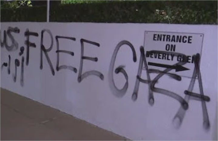Graffiti on a wall outside Beverly Hills Temple Sinai, to which a Jewish couple were walking for Shabbat services recently, when they were attacked by an assailant, who beat the man bloody and demanded, “Give me the [wife’s] earrings, Jew!” Random attacks on American Jews are increasing dramatically. 