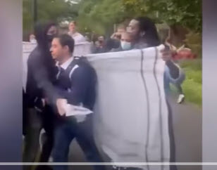 Harvard student is menaced by pro-Palestinian demonstrators and prevented from leaving after he attempts to take photos of them. Such illegal behaviors—as well as civil rights violations—are currently being challenged by law suits, donor outrage and Congressional legislation.(YouTube screenshot) 